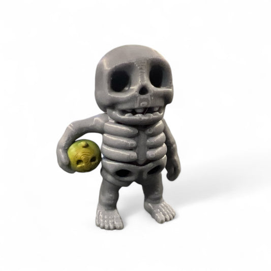 Mini Skeleton holding Pumpkin
